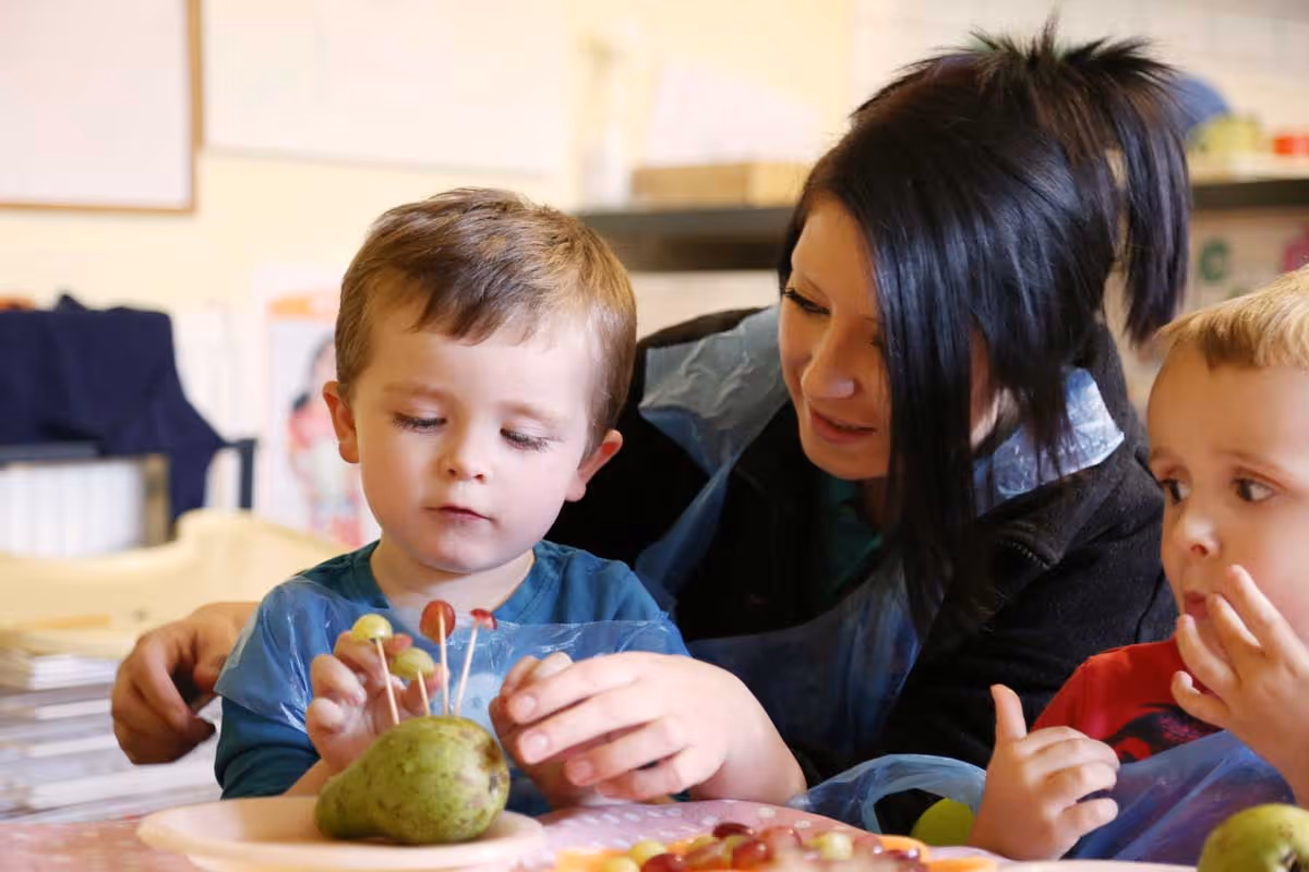 photo of a child eating potato