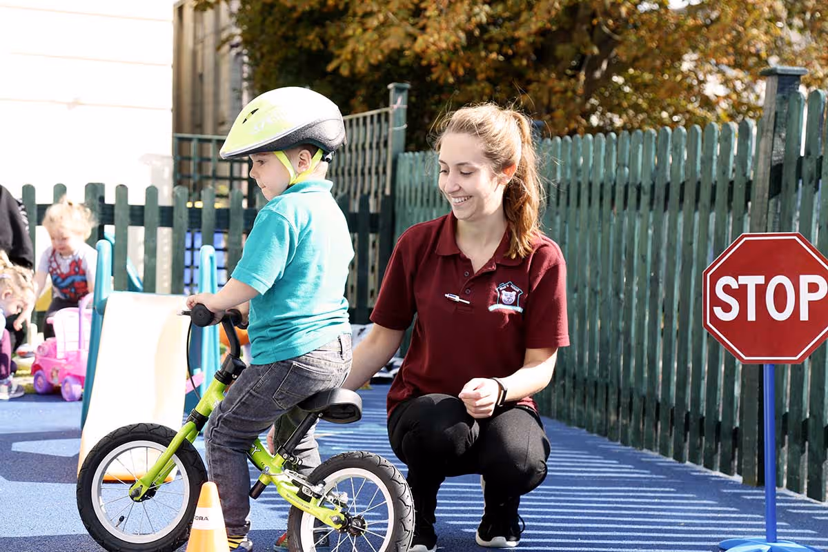 photo of a child riding a bike in the garden