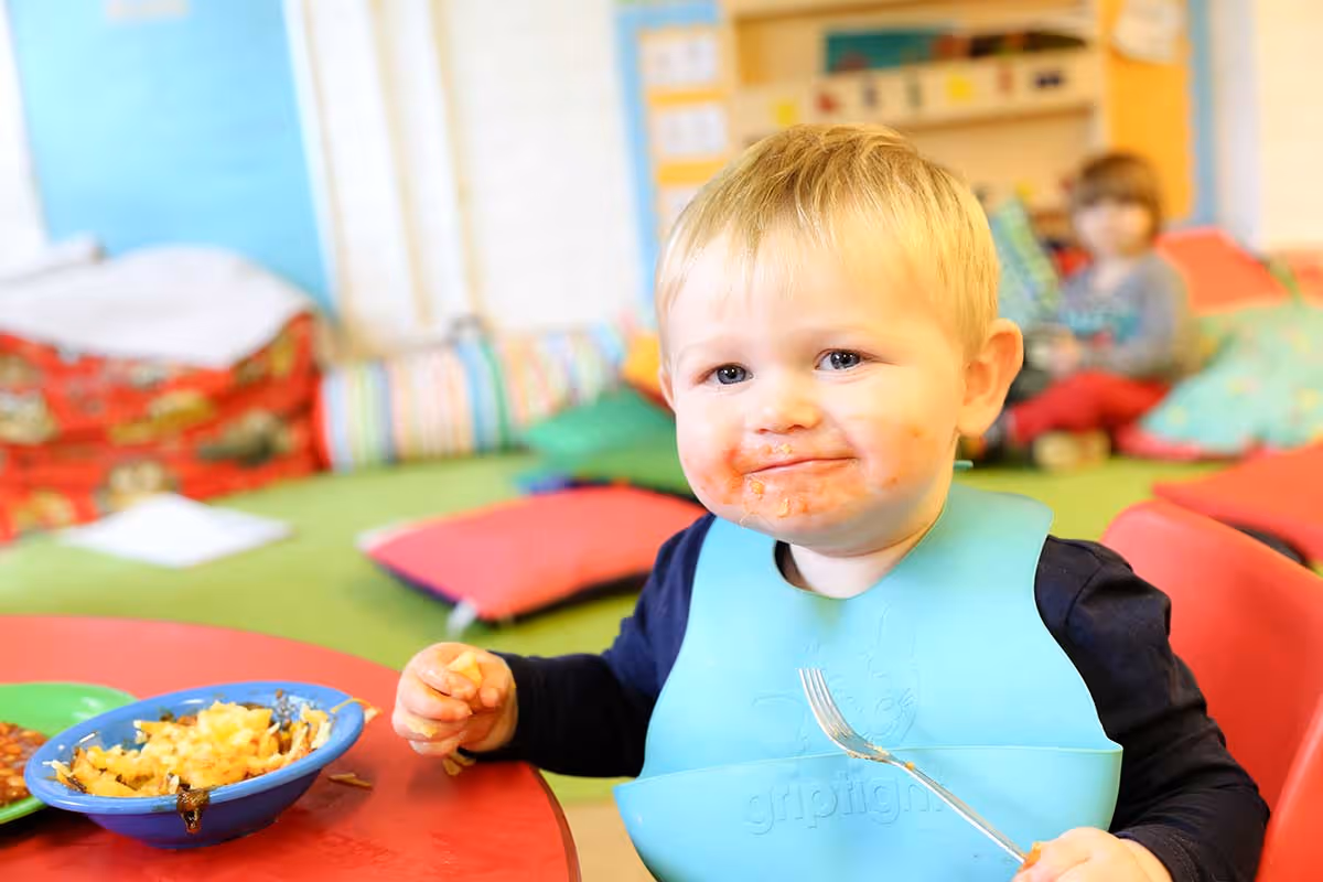 photo of a baby boy eating lunch