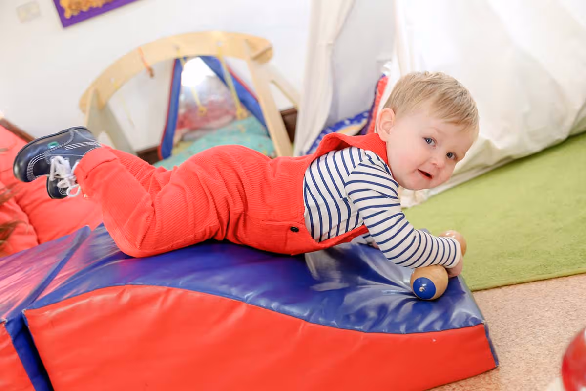 photo of a child playing in a soft-play room