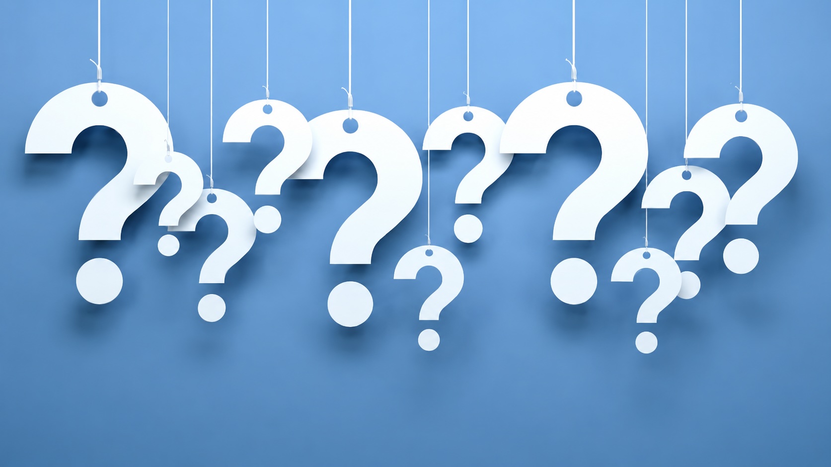 Image of paper question marks hanging from strings