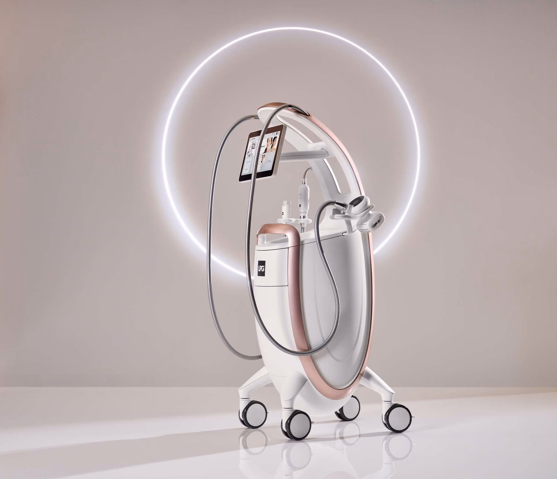 White and rose gold aesthetic medical device on wheels with a screen and flexible tubes, against a lit circular background.