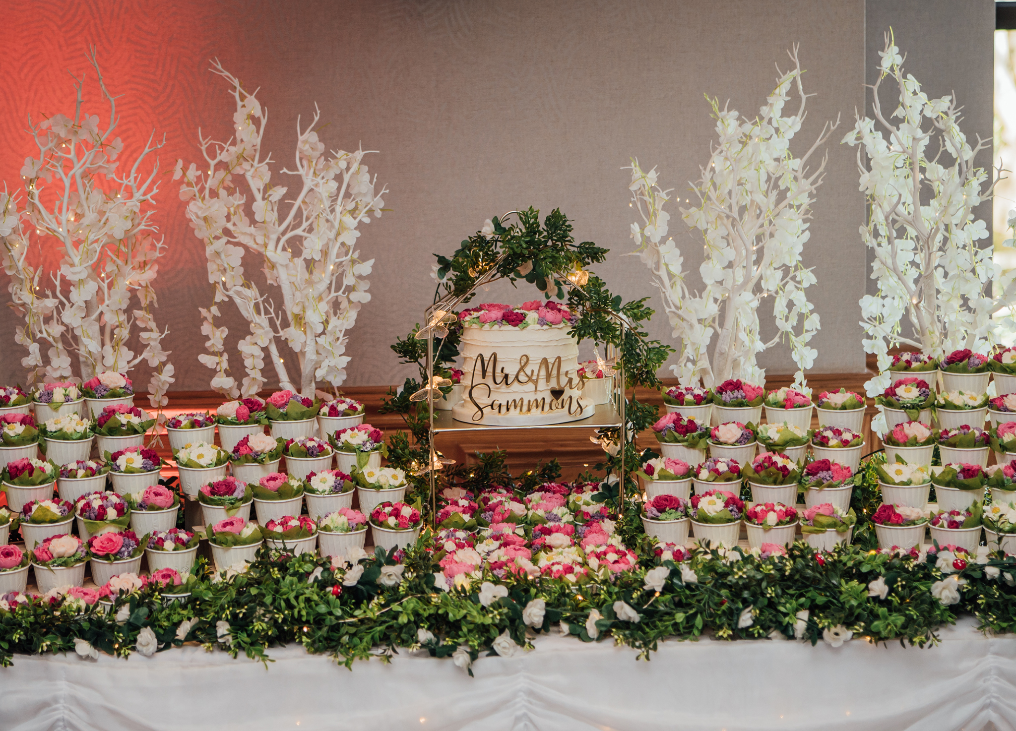 Colourful wedding cupcake garden display