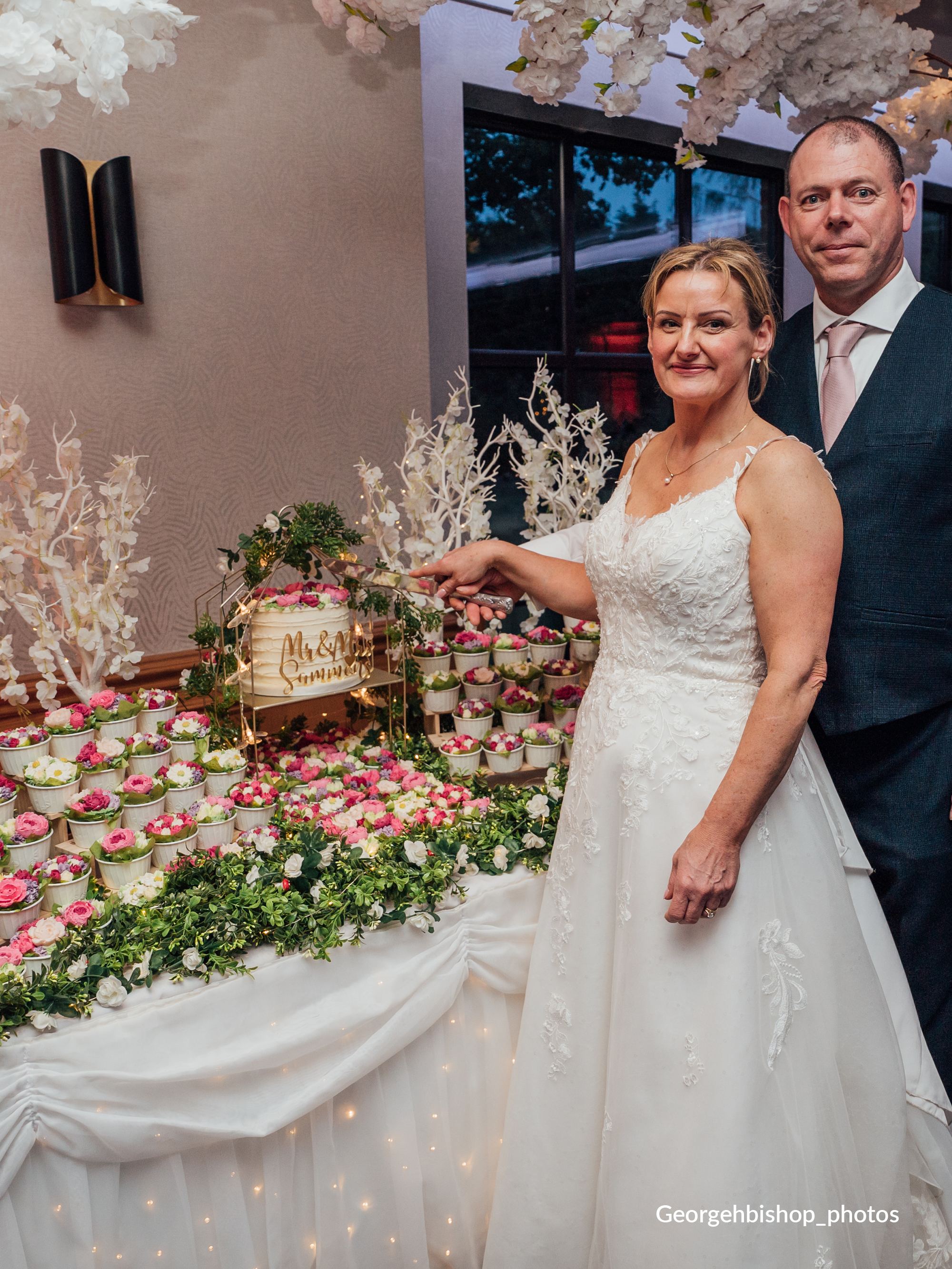Colourful wedding cupcake garden with bride and groom