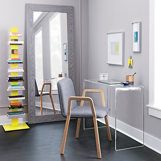 I like how the walls of this room complement the chair and frame of the mirror