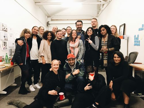 A group of people standing inside a creative office