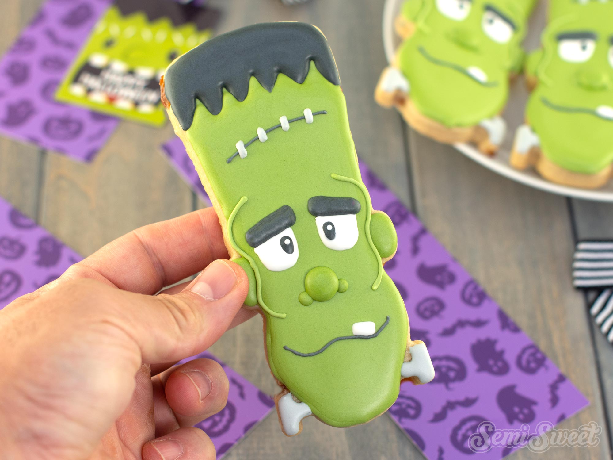 Showing off the finished Frankenstein cookie all decorated with royal icing