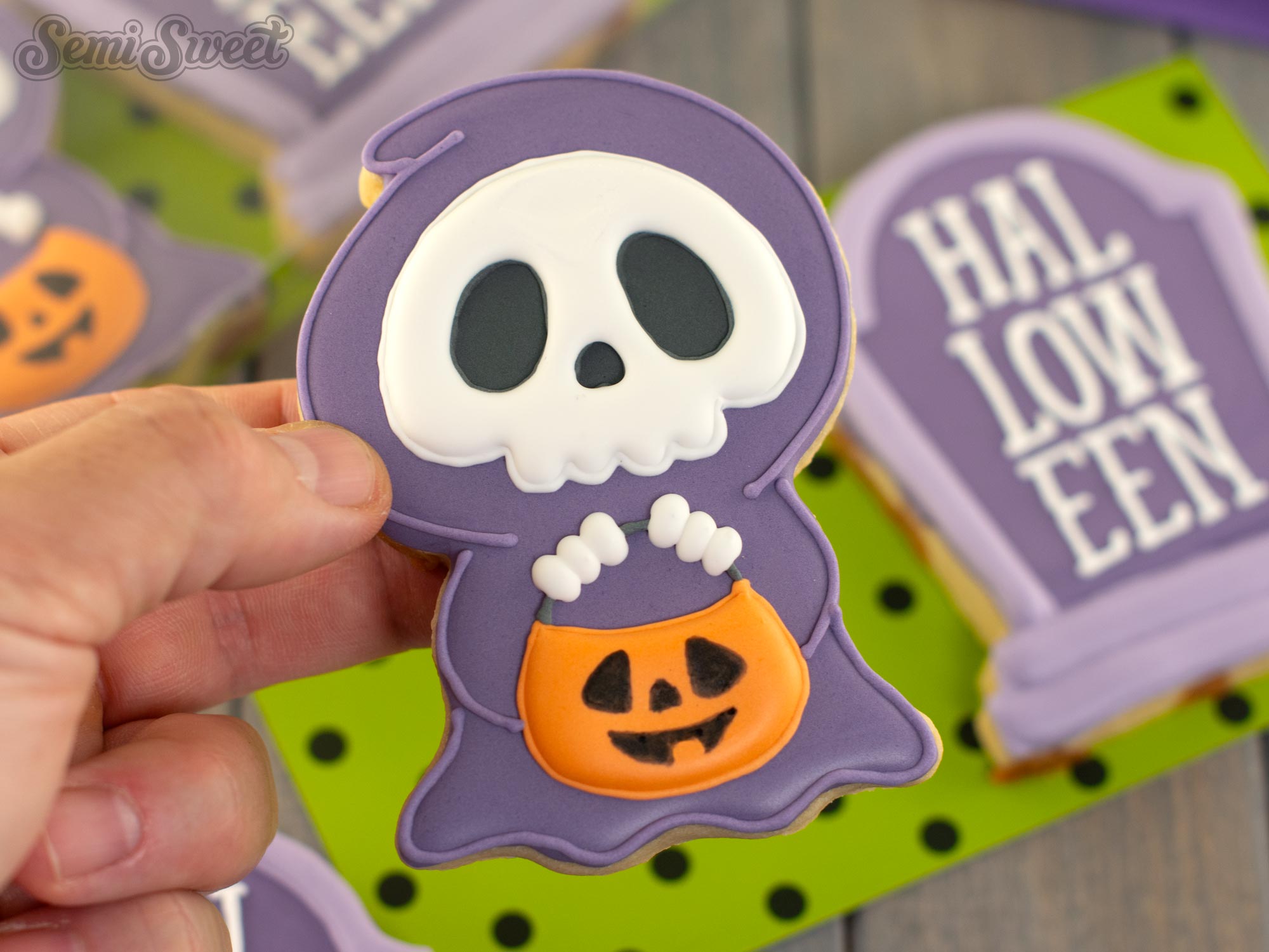 showing off a completed grim reaper cookie for Halloween.