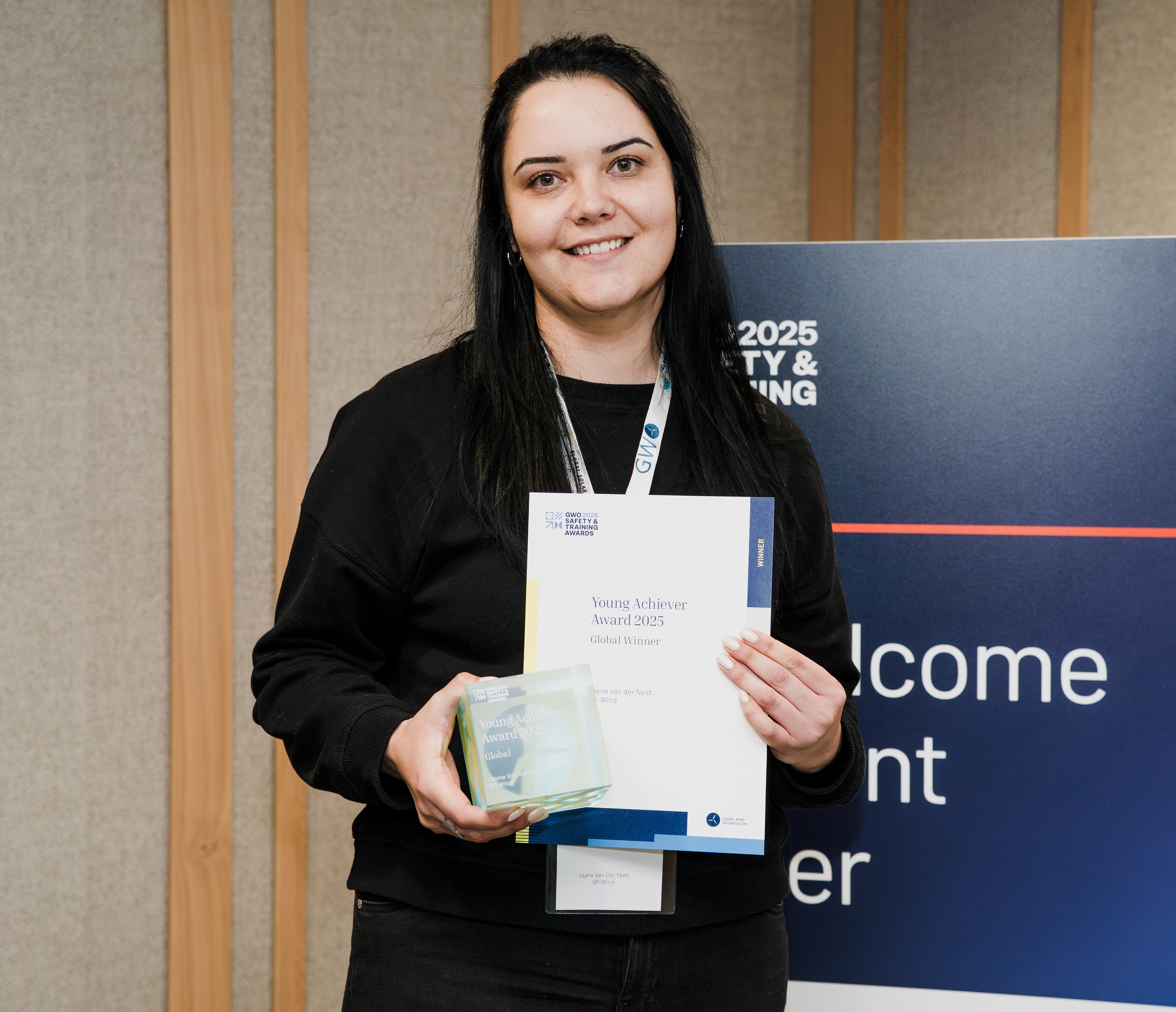 A winner from the GWO Safety & Training Forum and Awards 2026 holds her certificate and trophy 