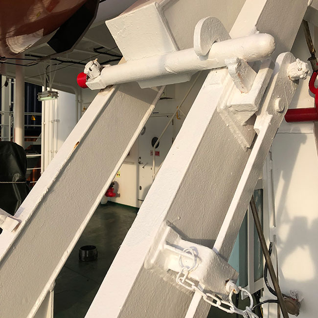 Lifeboat davit arm stopper in locked position