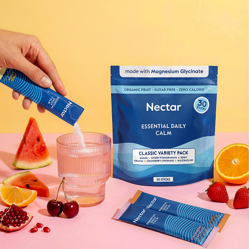 Kids holding strawberry-flavored tooth powder tubes in a pink-themed studio product shoot.