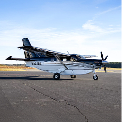 Cessna 208 Caravan parked on a runway.