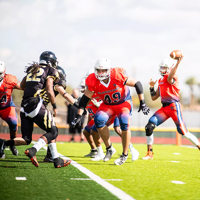 American football players competing in a game on a professional turf field during live play.