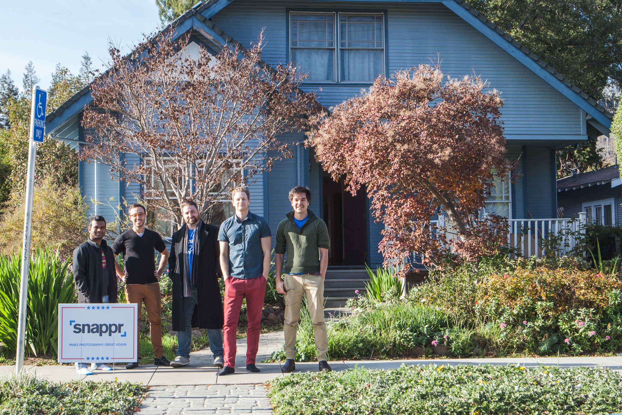 Snappr team standing in front of their YC house in Mountain View with Make Photography Great Again campaign sign on lawn