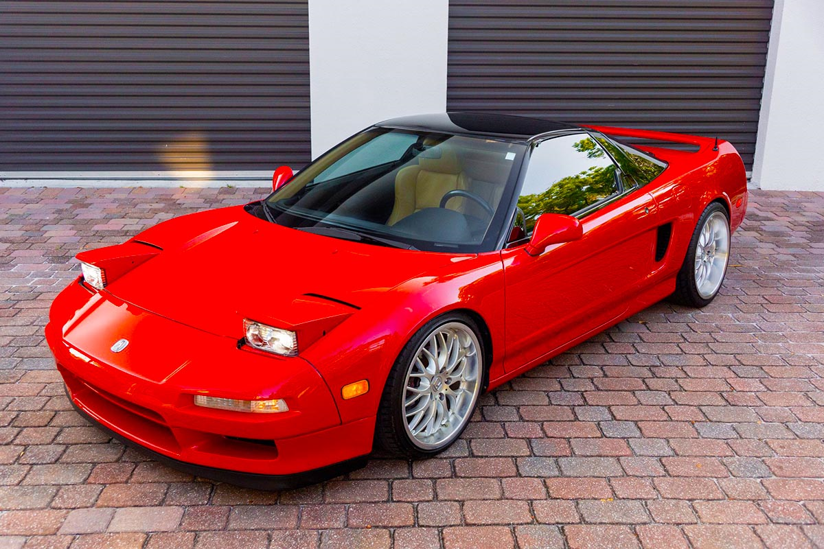 Red Acura NSX sports car parked on a brick driveway — high-quality dealership photography for online car gallery