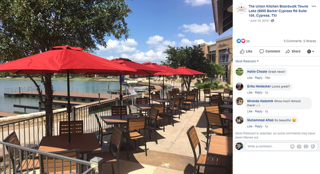 Facebook post from a lakefront restaurant showing outdoor patio seating with red umbrellas and customer comments — social media engagement