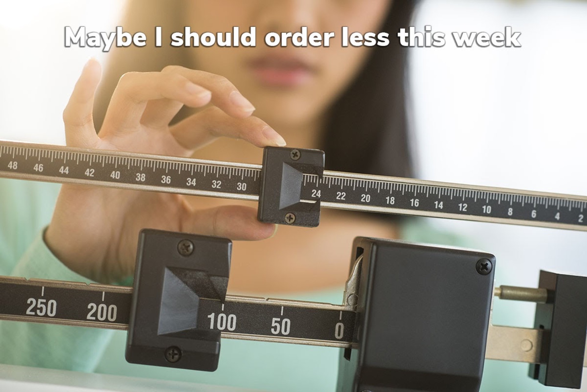 Woman adjusting a balance scale with text overlay about ordering less — COVID-19 weight gain concerns slowing food delivery orders