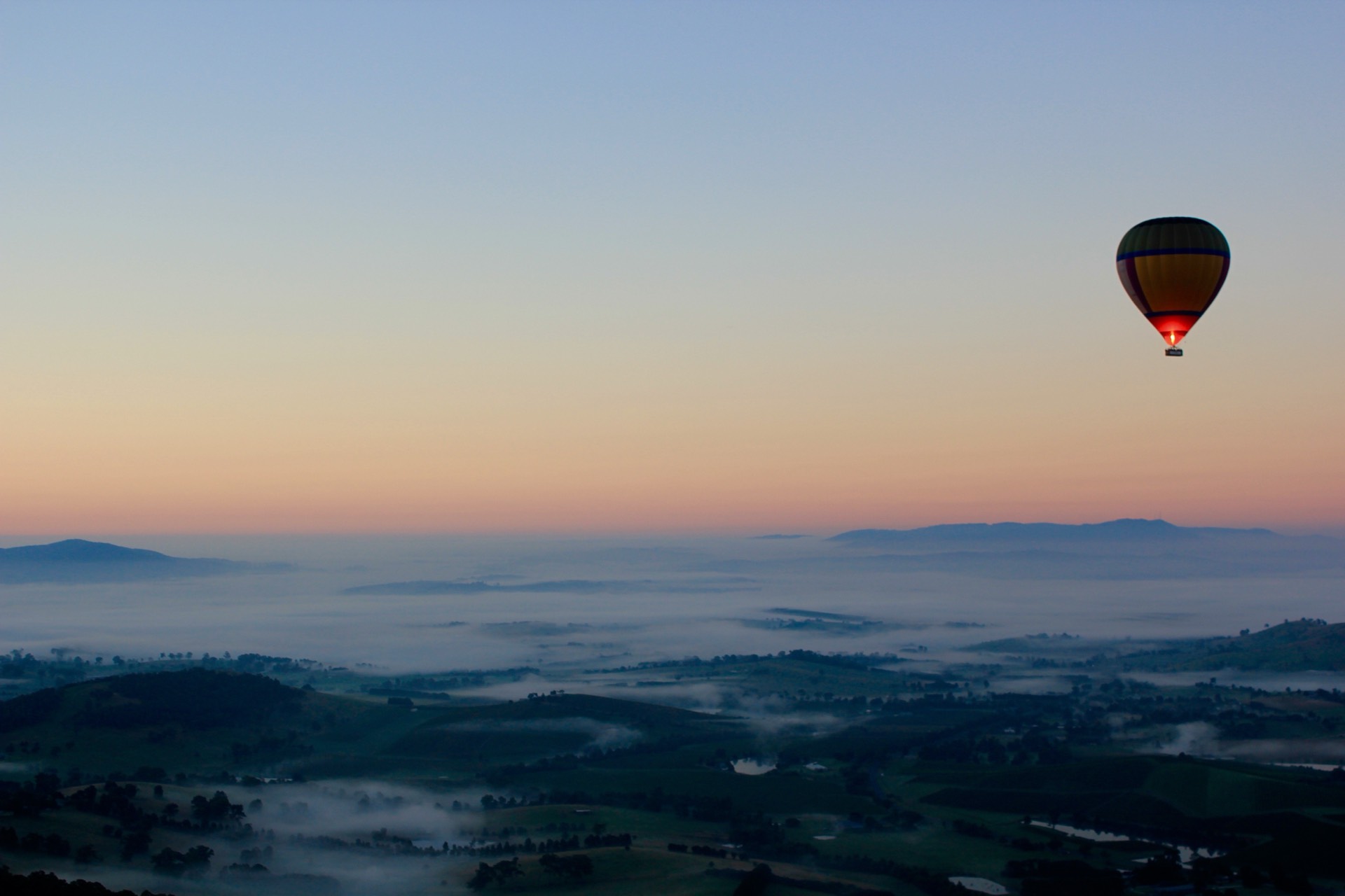 Hot air balloon floating over misty Yarra Valley hills at dawn, the romantic setting near The Manor on High Melbourne wedding venue