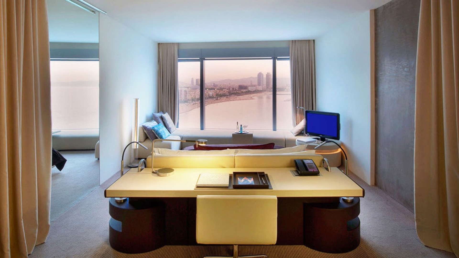W Hotels Barcelona suite with spacious work desk and panoramic city and coastline view, captured with professional photography