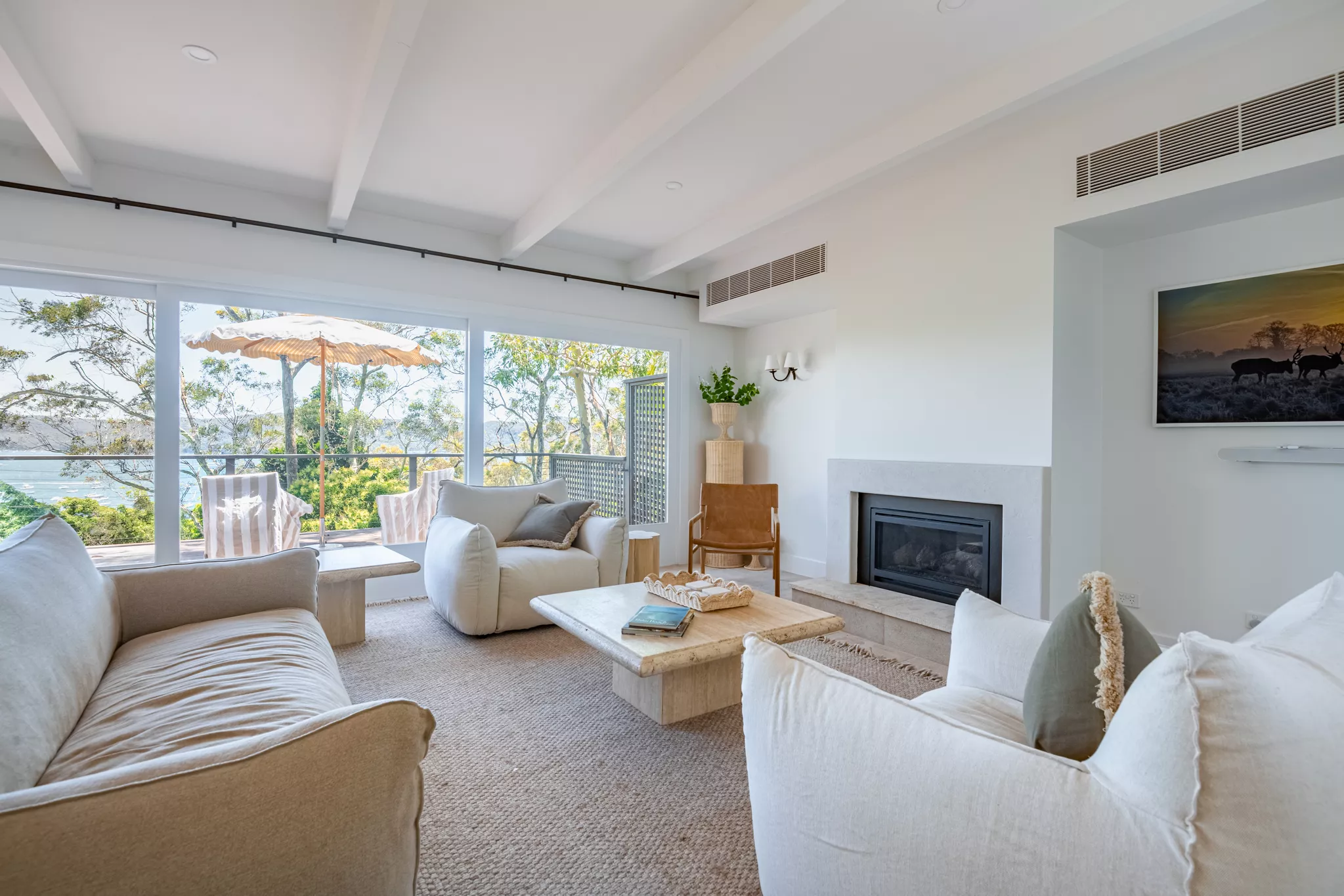 Light-filled coastal living room staged for a real estate video tour.