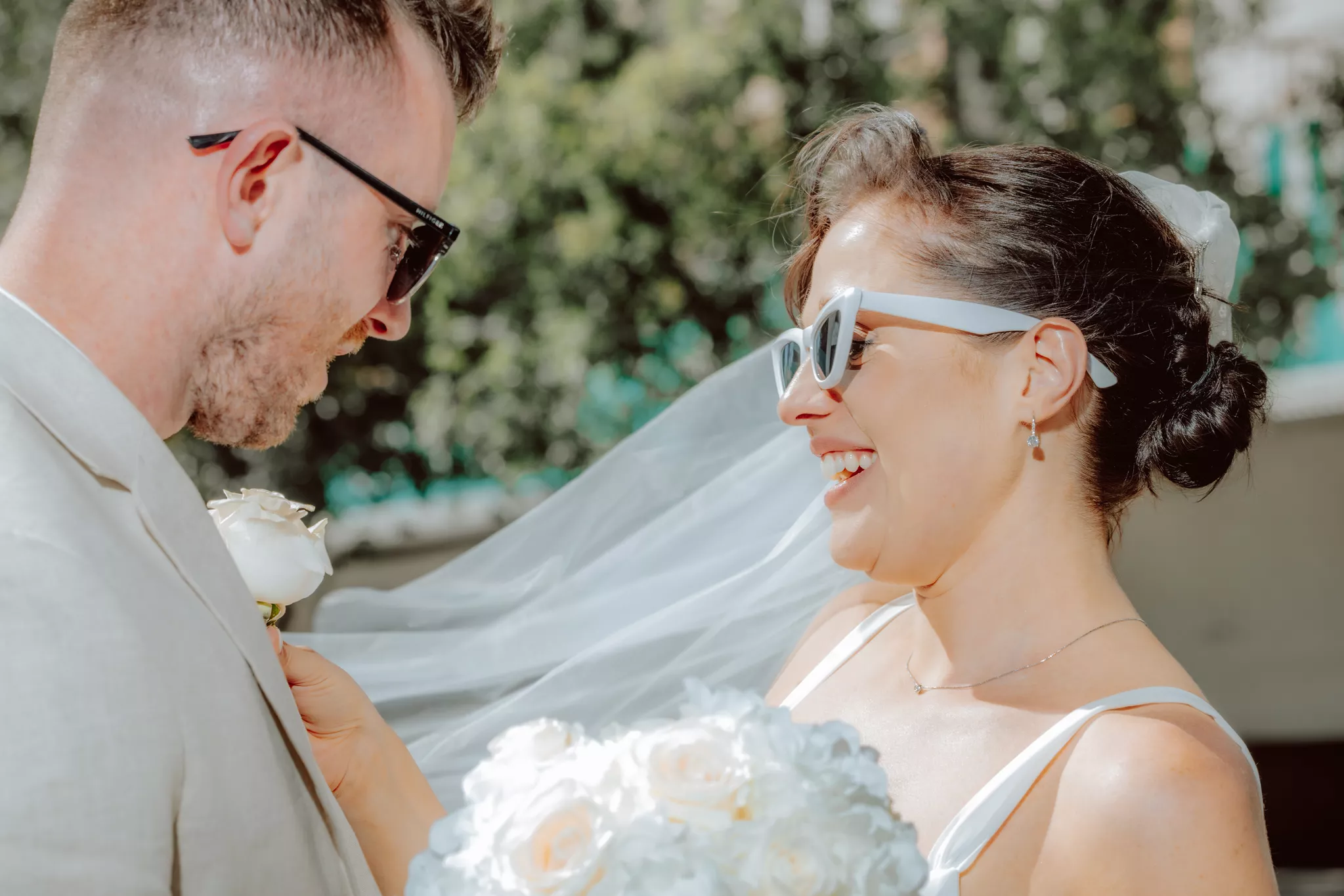 Sunlit candid of a bride and groom — the kind wedding photographers and videographers live for.