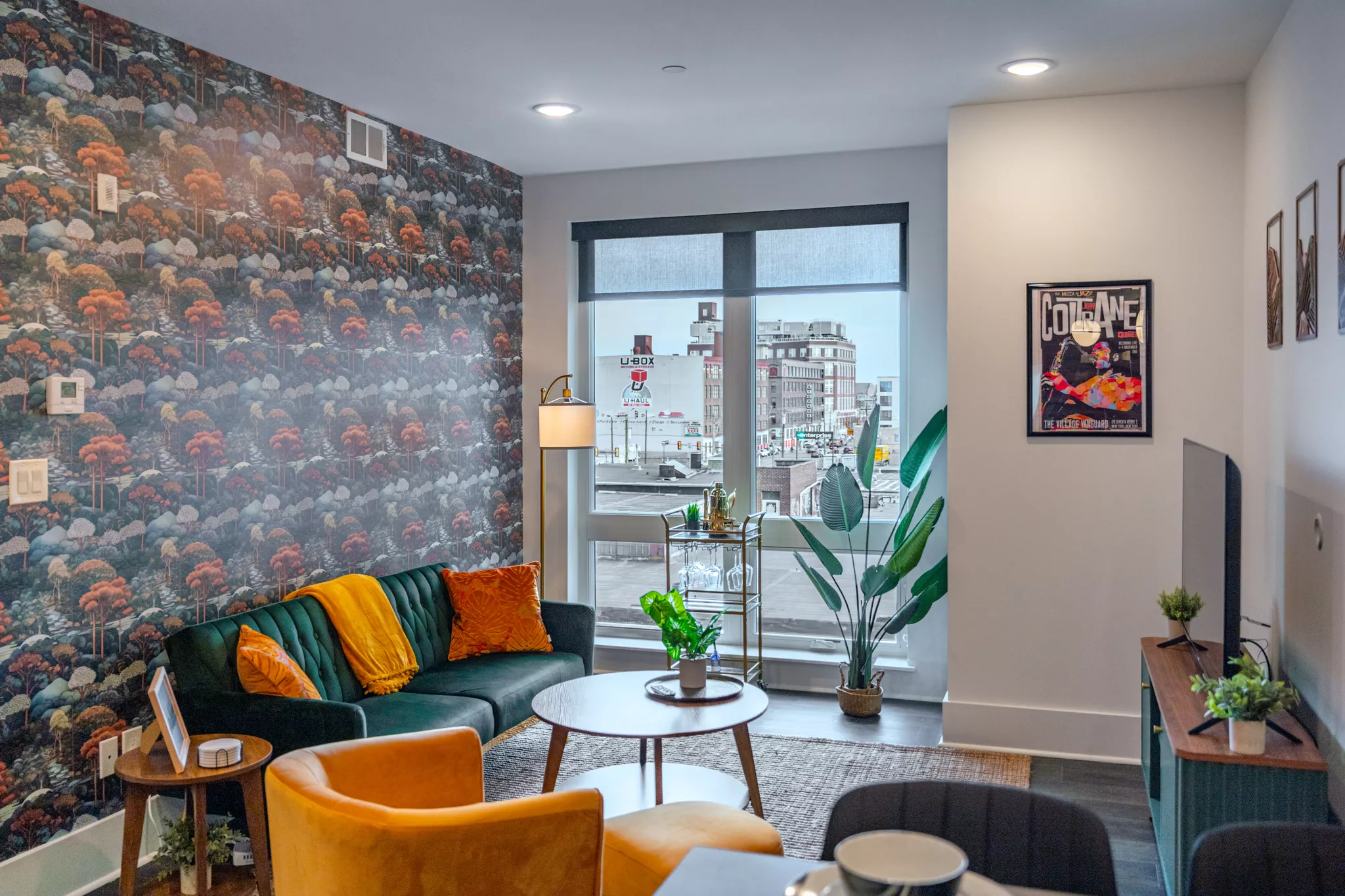 Eclectic urban apartment with green sofa, staged for a real estate video tour.
