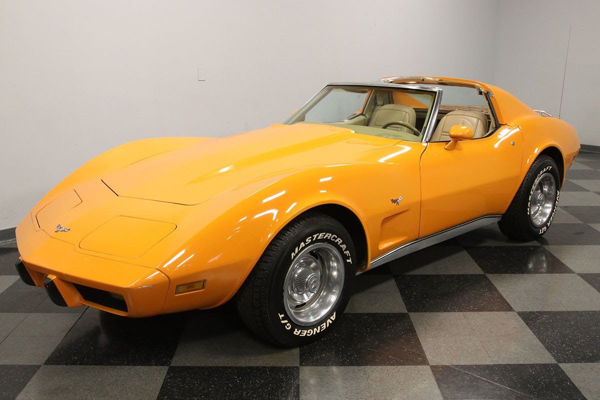 Orange Corvette Stingray C3 in a showroom on the Motorious auction platform