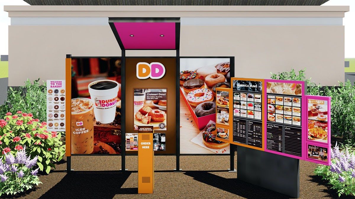 Dunkin' Donuts drive-thru menu board displaying food photos and order station with branded signage