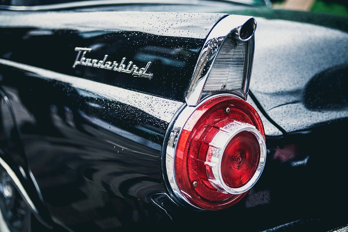 Close-up of a Ford Thunderbird taillight and chrome badge showing the detail that professional car photography captures