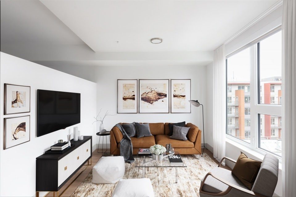 Virtually staged living room with leather sofa, wall-mounted TV, and contemporary artwork