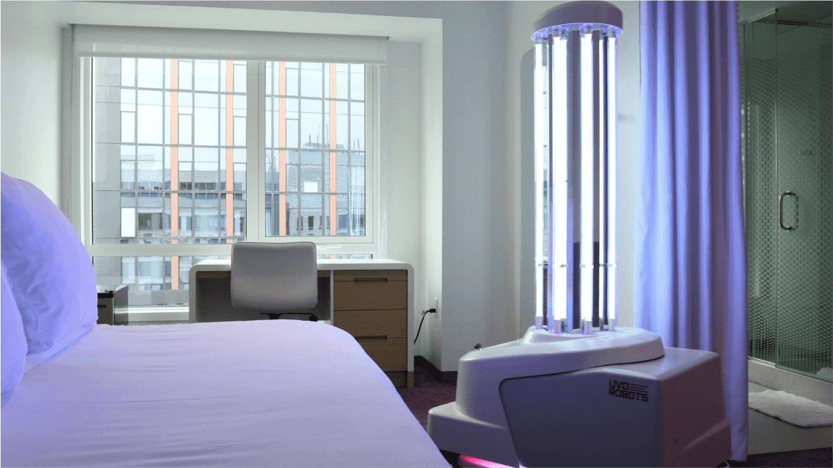 UV disinfection robot sanitizing a hotel room with ultraviolet light, showcasing advanced cleaning technology for post-pandemic hospitality