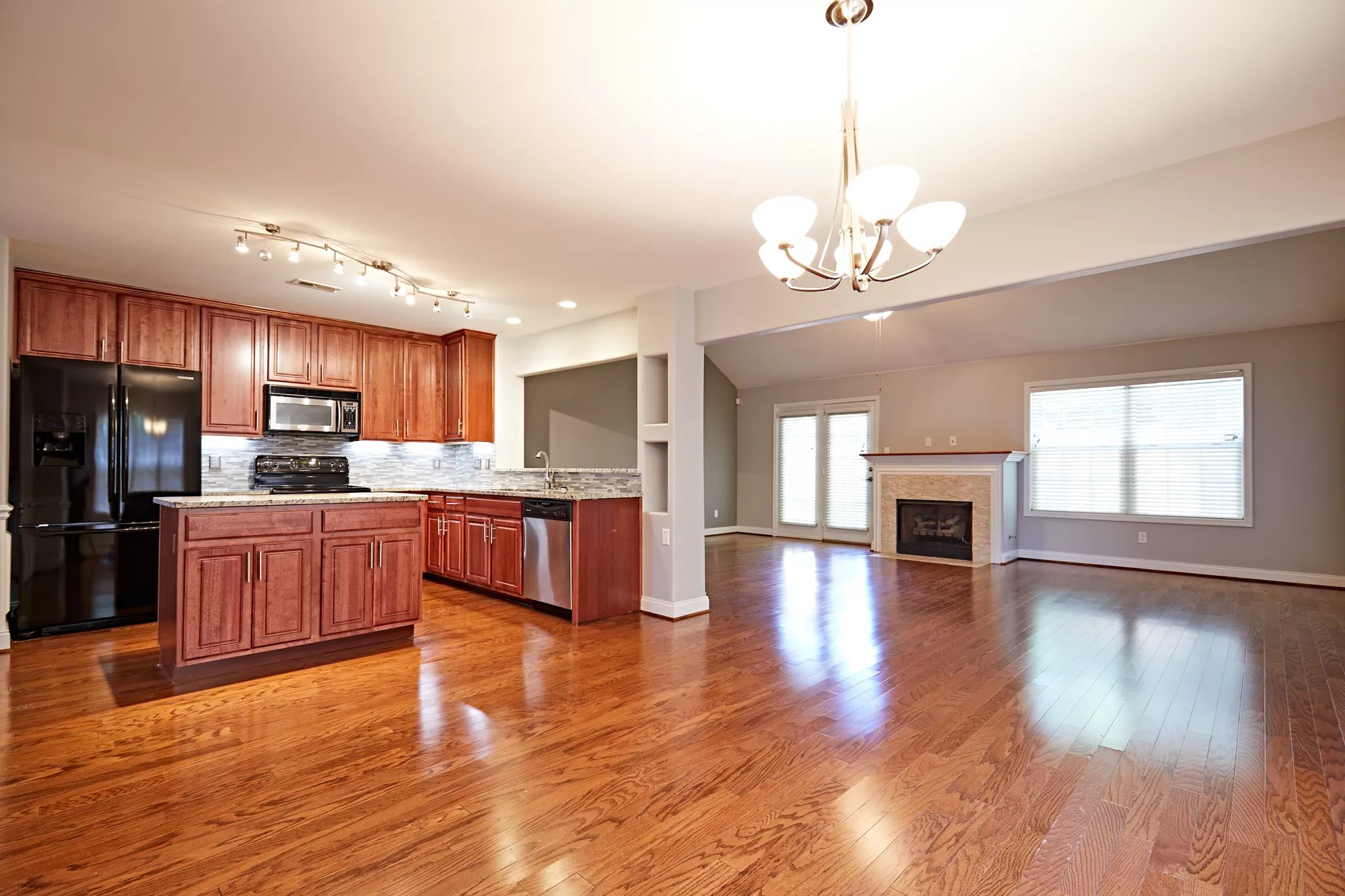 Open-plan kitchen and living area captured by a Matterport photographer.