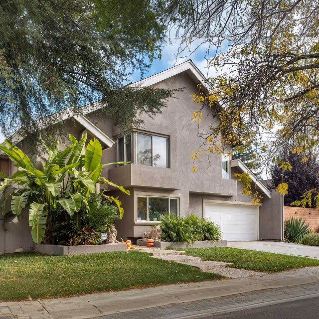 Suburban two-story home with landscaped front yard and driveway