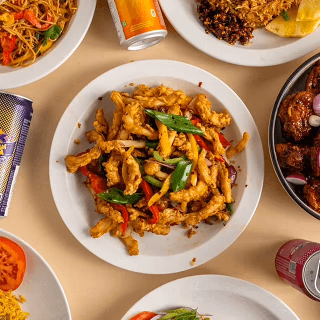 Mexican dishes including tacos, carne asada fries and assorted sides served on a table