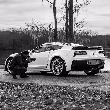 Vehicle photographer capturing dealership inventory images for online car listings