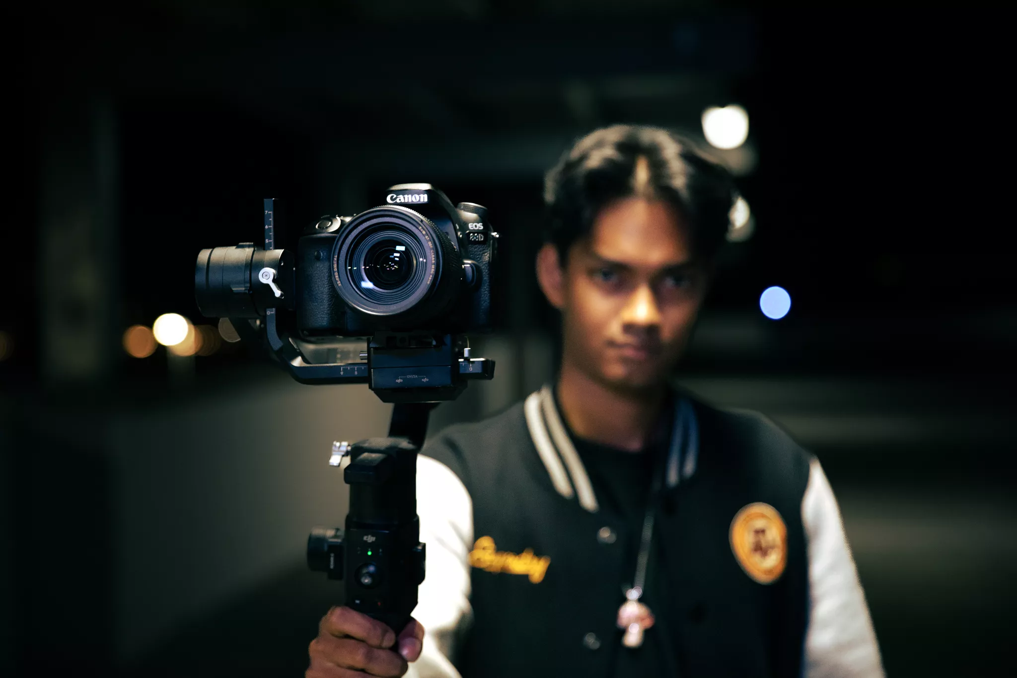 Gimbal operator steadies a camera on a night videography services shoot