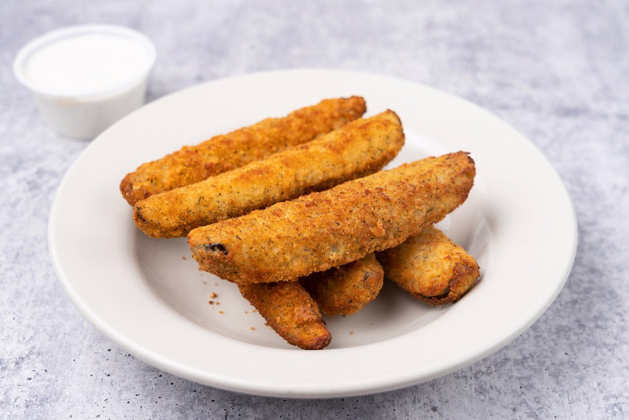 Plain food packshot on a white plate, the kind of clean studio image AI photo editing restages into new scenes