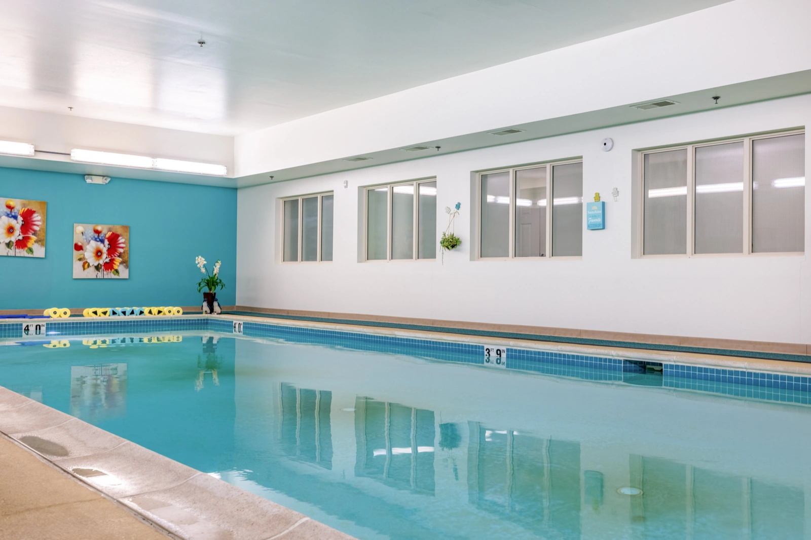 Empty indoor pool with still water and depth markers, shot as a Booking.com amenity photo