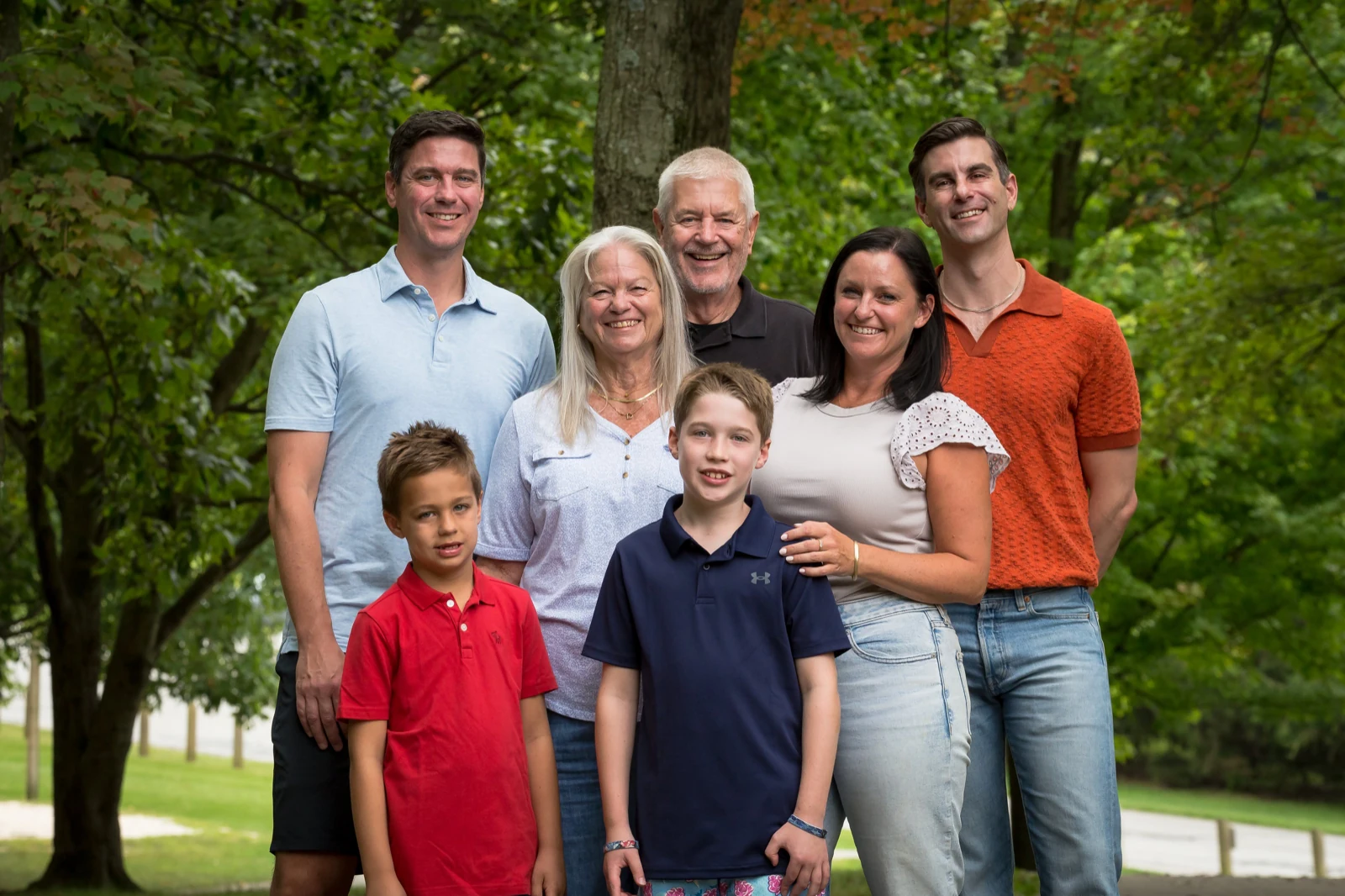 Classic family photo poses: three generations standing with heads staggered