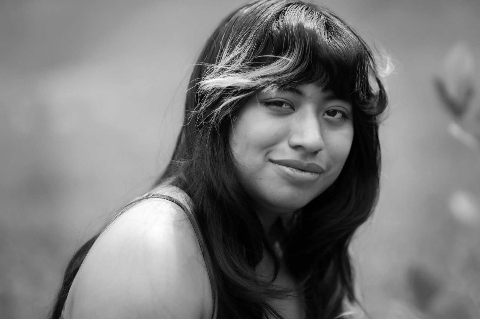 Black and white headshot examples: woman glancing over her shoulder in soft natural light.