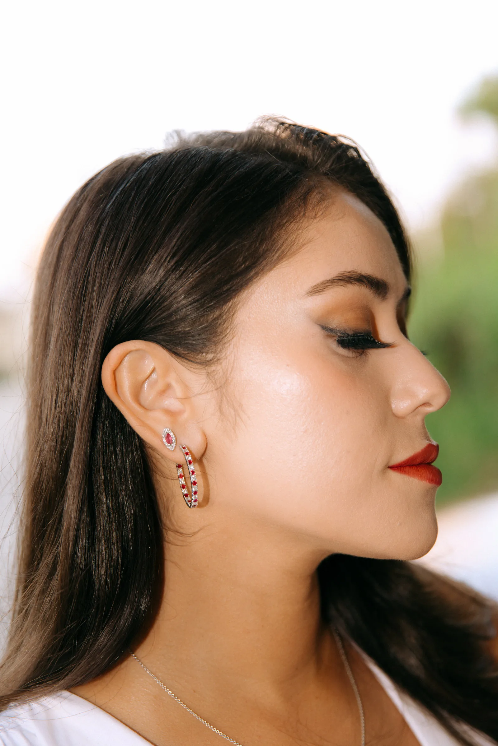 Poses for women: profile close-up showing jawline, earrings and red lipstick