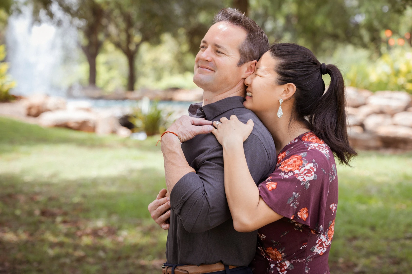 Romantic couple poses close-up: a tight hug, cheek to cheek, eyes closed