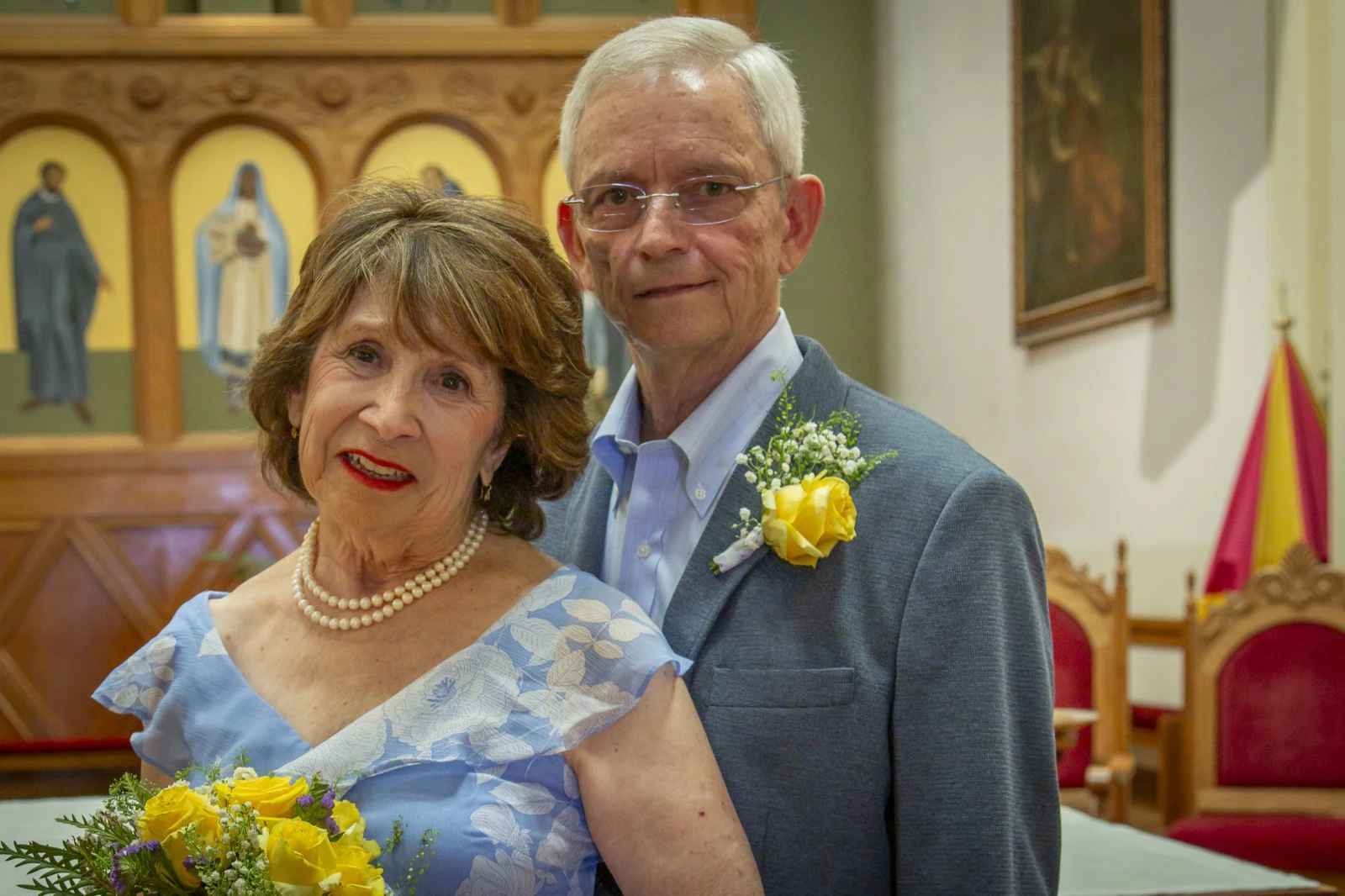 Anniversary photo ideas: an older couple dressed up for a vow renewal in a church