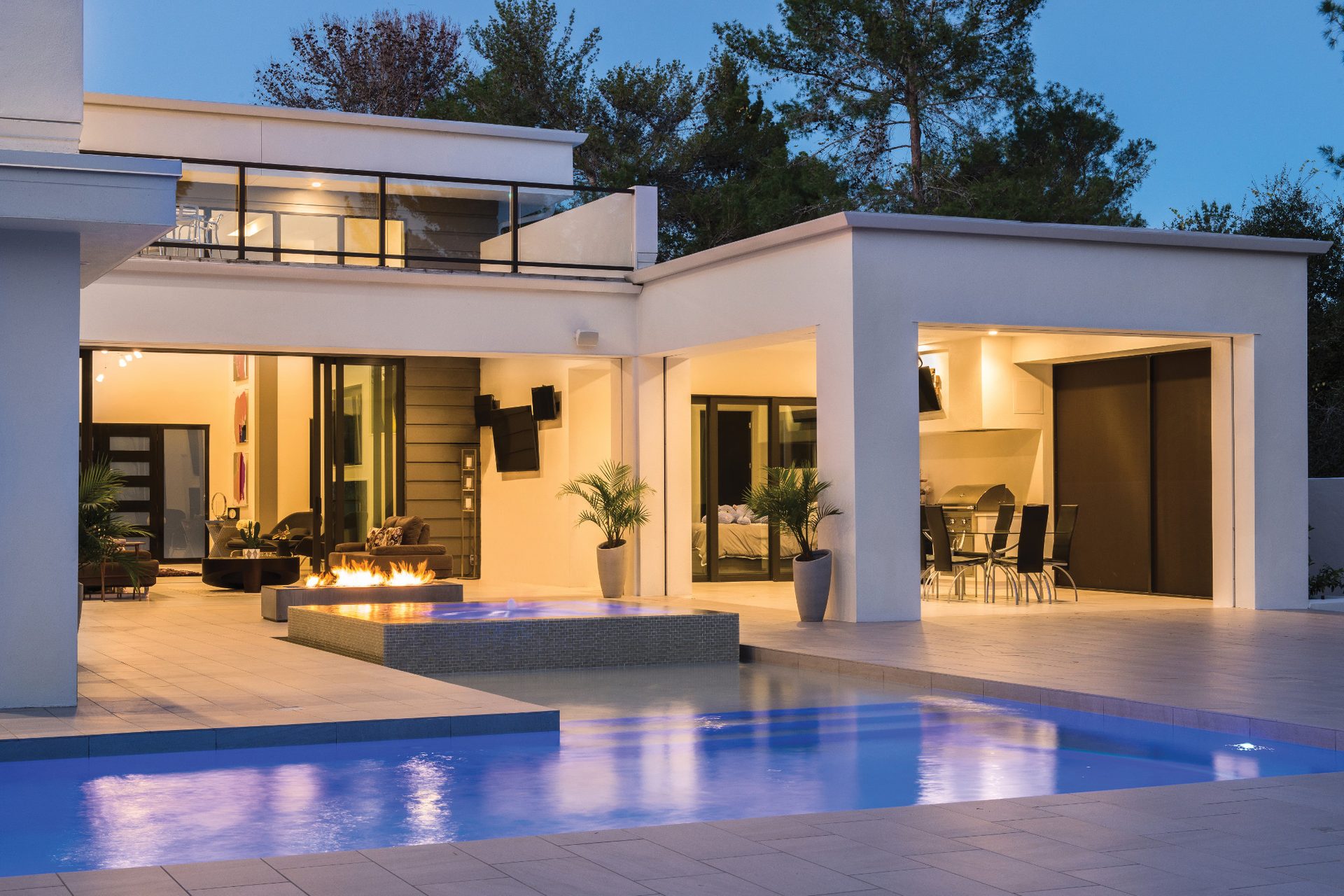 Luxury estate landscape lighting at dusk