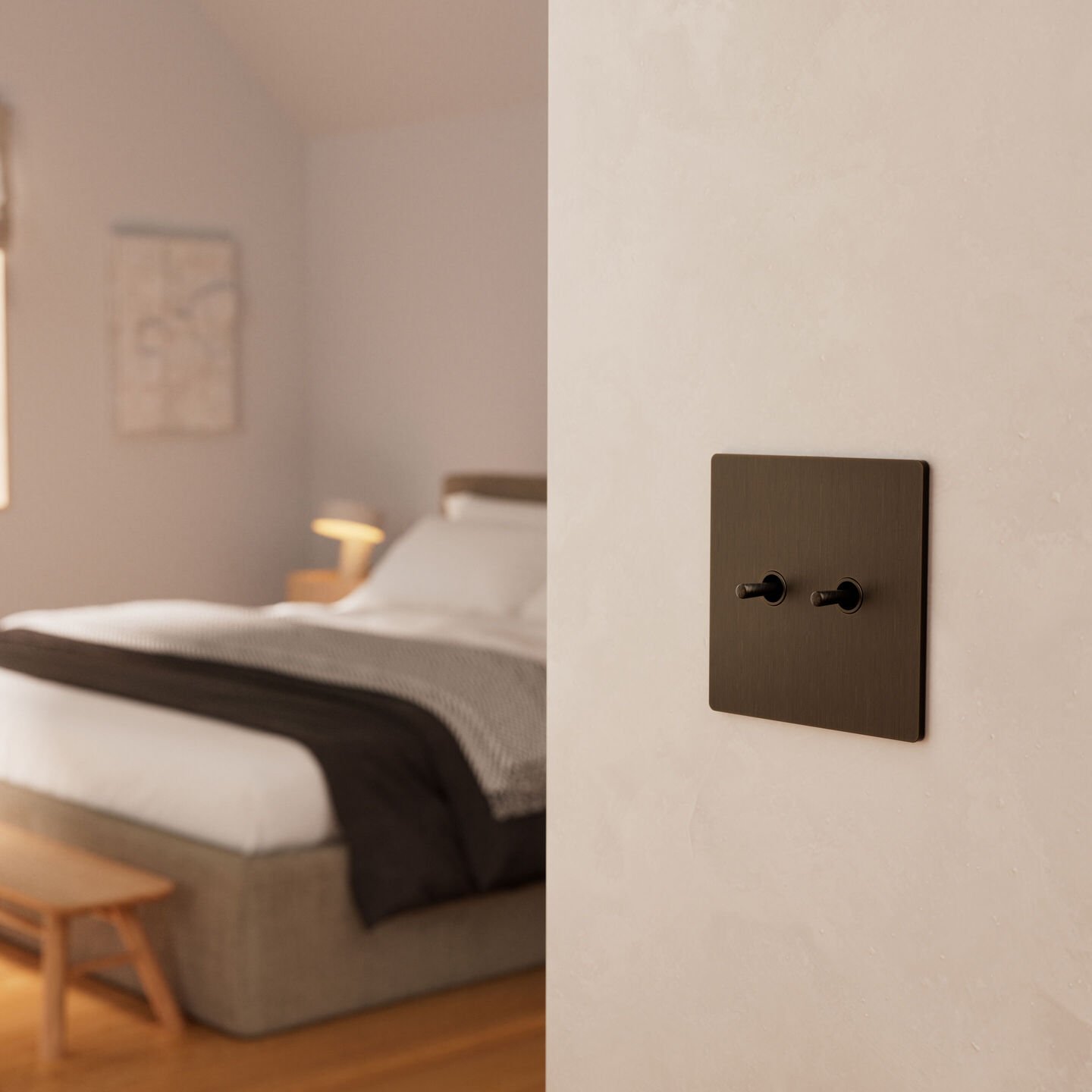 Lutron Aviena keypad in Aged Bronze installed on a plaster wall beside a bedroom