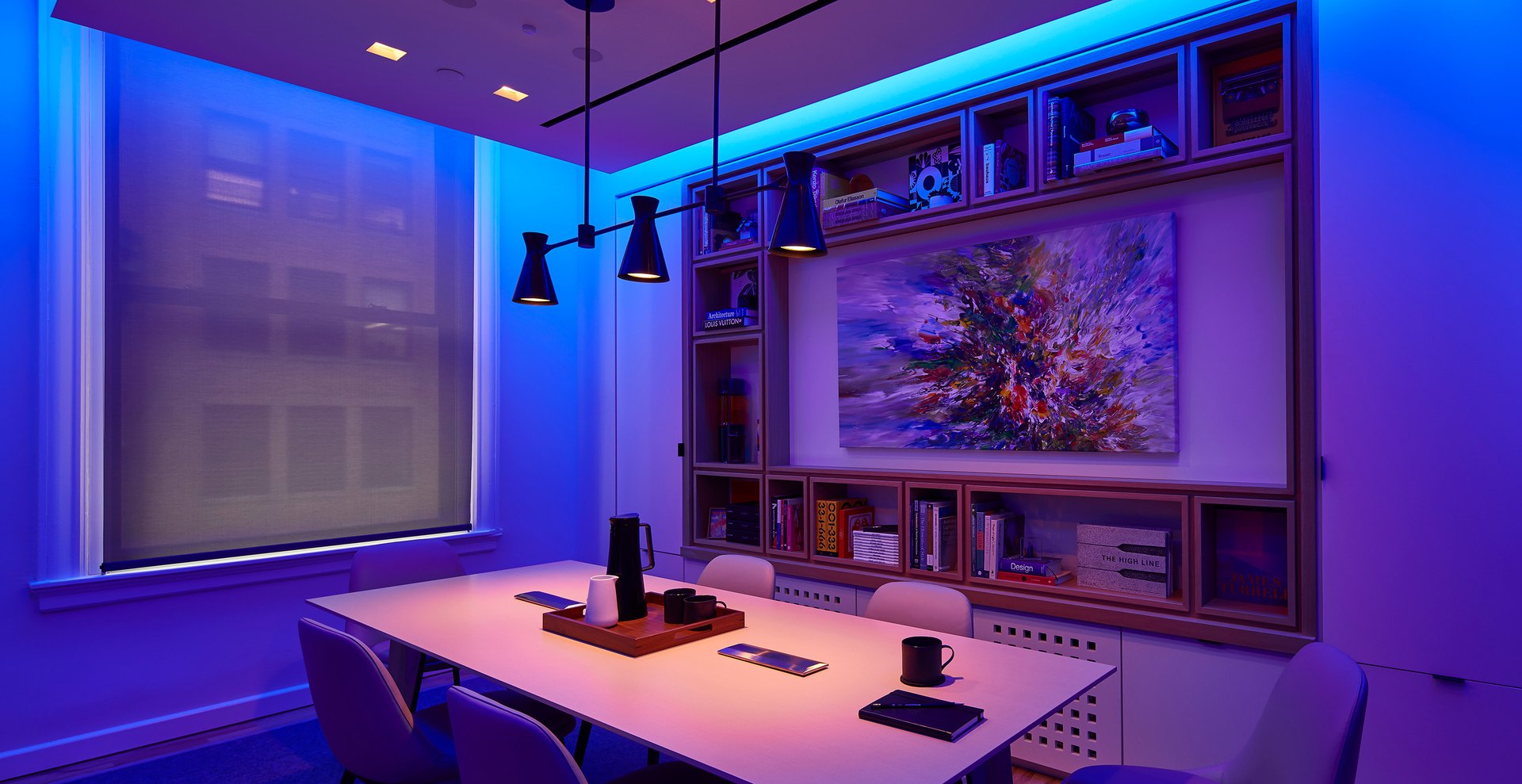 Room with saturated colour on the architecture and white light on work surfaces