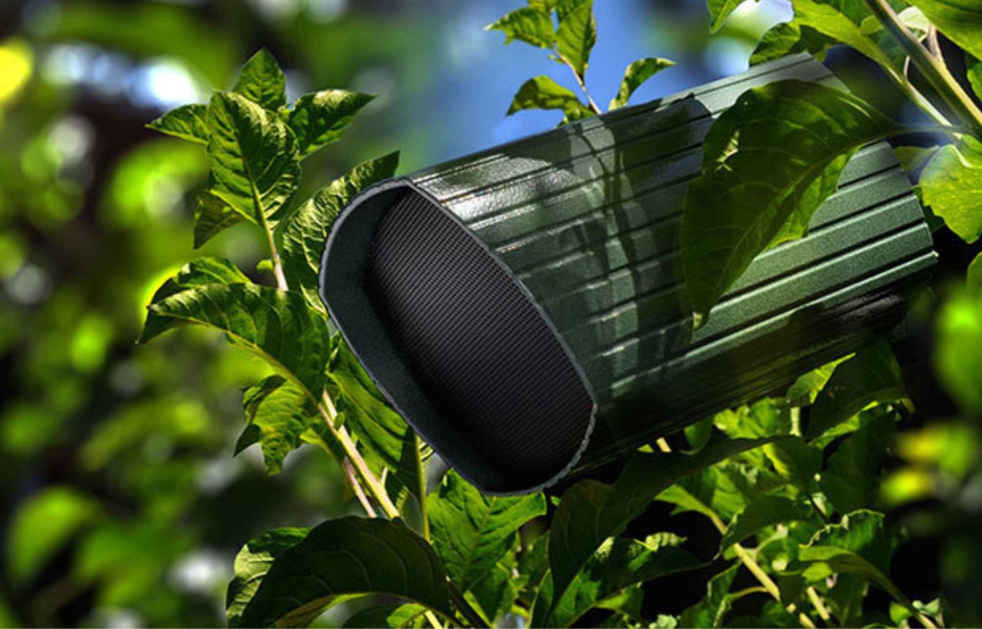 Landscape speaker mounted among mature foliage