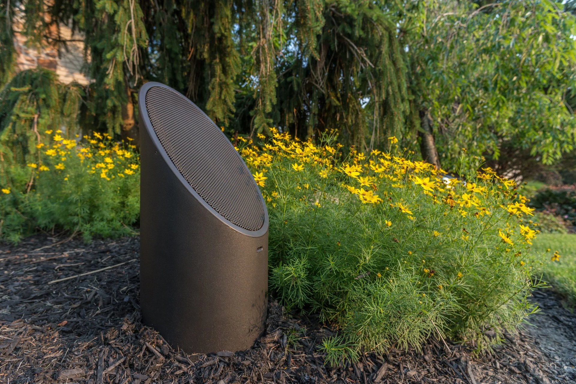 Coastal Source outdoor landscape speaker integrated among garden wildflowers
