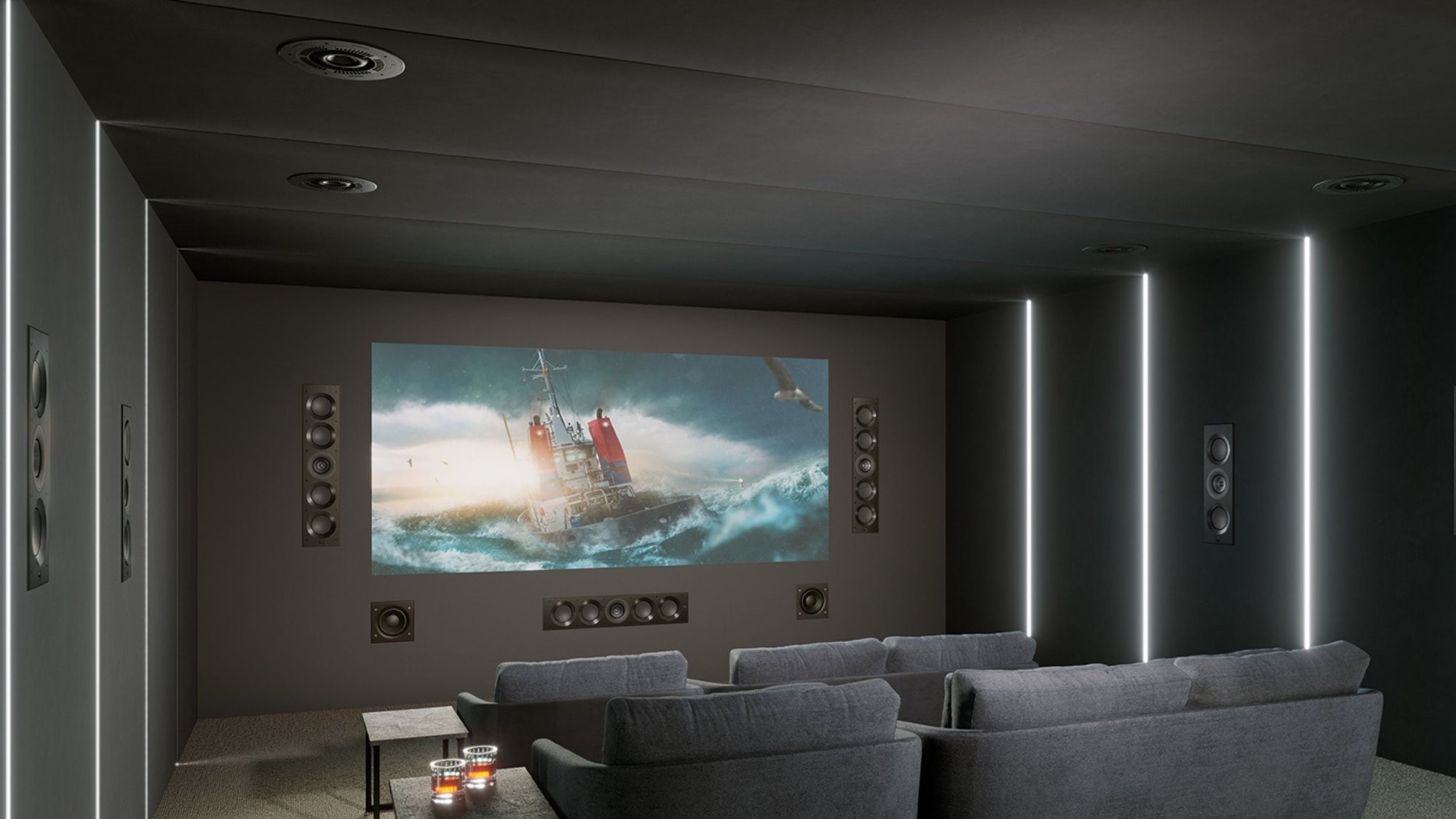Dedicated theater with a projection screen and in-wall speakers