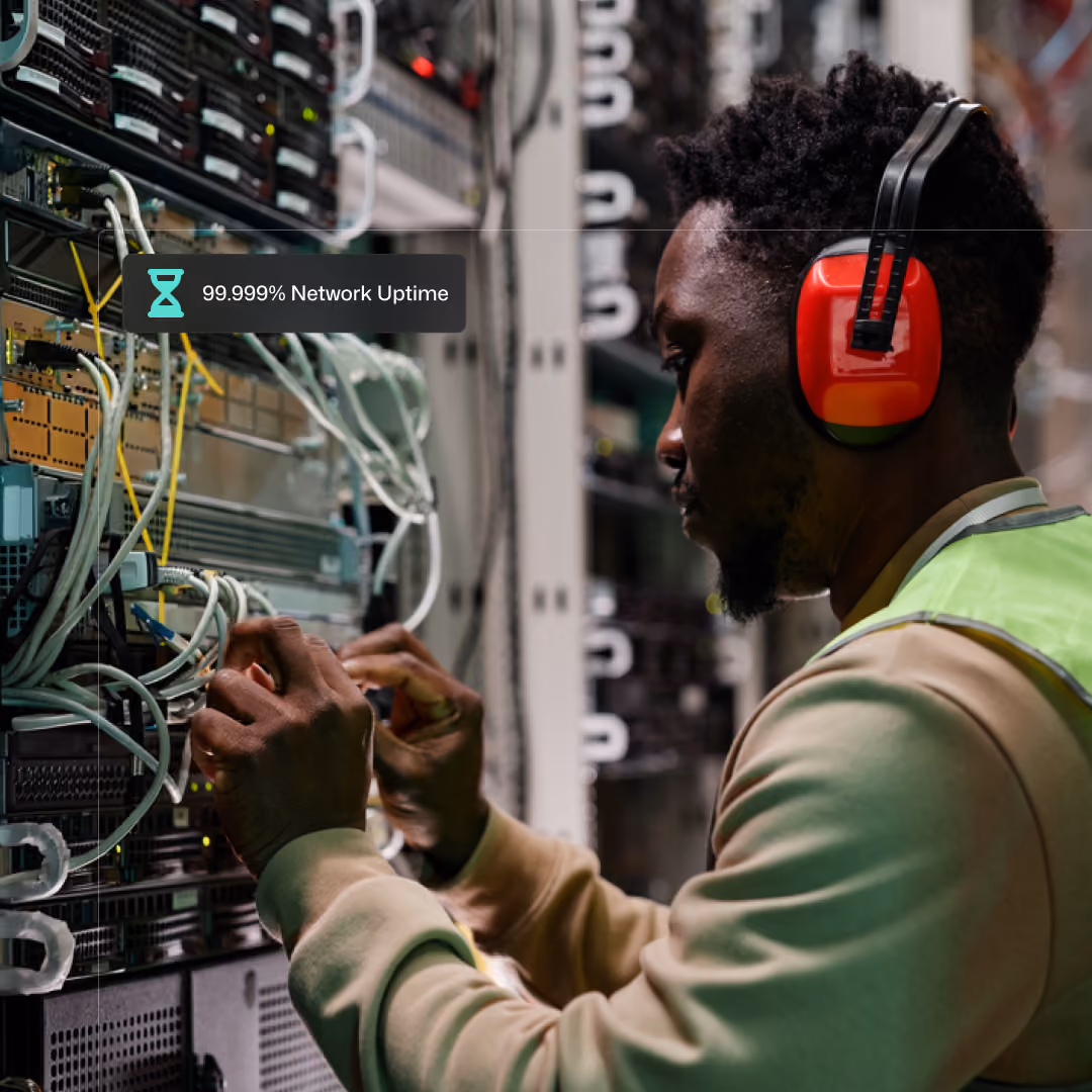 A network engineer performing maintenance on a server rack.